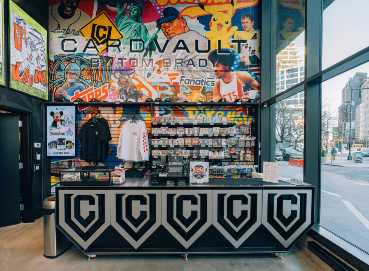 CardVault Brooklyn interior showing sports cards, Pokémon products, apparel, and a branded checkout counter