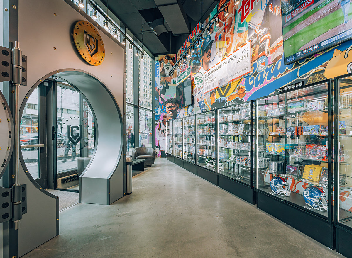 CardVault Brooklyn sports card shop interior with display cases, memorabilia, and colorful sports murals